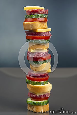 Sliced â€‹â€‹pieces of sausage, salami, cheese, cucumber and tomato. fast food. ingredients for pizza. calories and diet Stock Photo